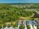 An aerial view pinpoints this home near a lake, greenery, and community amenities at 6807 Habitat Dr, St Cloud, FL 34773