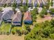 Aerial view of a two-story home with an open backyard adjacent to neighboring homes in a tidy suburban neighborhood at 6807 Habitat Dr, St Cloud, FL 34773