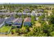 Aerial view of a two-story home in a suburban neighborhood with mature trees and well-maintained lawns on a sunny day at 6807 Habitat Dr, St Cloud, FL 34773