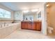 Beautiful bathroom boasts double sinks, granite countertops, and a large soaking tub at 6807 Habitat Dr, St Cloud, FL 34773