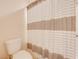 Bathroom featuring a toilet and a shower with a curtain at 6807 Habitat Dr, St Cloud, FL 34773