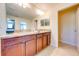 The elegant bathroom features double sinks, gorgeous granite countertops, and wood cabinetry at 6807 Habitat Dr, St Cloud, FL 34773