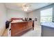 Bedroom with a ceiling fan, window, and wooden bed frame at 6807 Habitat Dr, St Cloud, FL 34773