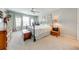 Bright bedroom with neutral carpeting features a large bed and plenty of natural light at 6807 Habitat Dr, St Cloud, FL 34773