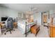 This bedroom features neutral carpeting, desk area, queen sized bed and soothing paint colors at 6807 Habitat Dr, St Cloud, FL 34773