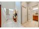 Inviting entryway with tile flooring, a white front door, and a view of the bathroom at 6807 Habitat Dr, St Cloud, FL 34773