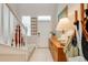 Bright entryway featuring a white front door, tile flooring, and staircase with white railings at 6807 Habitat Dr, St Cloud, FL 34773