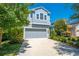 Charming two-story home featuring a gray garage, white trim, and well-manicured landscaping at 6807 Habitat Dr, St Cloud, FL 34773