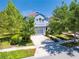 Charming two-story home featuring a gray garage, and well-manicured landscaping with mature trees at 6807 Habitat Dr, St Cloud, FL 34773