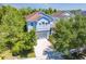 Charming home with a well-maintained lawn, mature trees, and a spacious driveway at 6807 Habitat Dr, St Cloud, FL 34773