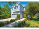 Charming two-story home featuring a gray garage, yellow door, and well-manicured landscaping at 6807 Habitat Dr, St Cloud, FL 34773