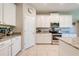 Bright kitchen with white cabinets, granite countertops, tiled floor and stainless steel appliances at 6807 Habitat Dr, St Cloud, FL 34773