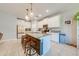 Bright kitchen featuring a central island with granite countertops, stainless steel appliances, and modern cabinetry at 6807 Habitat Dr, St Cloud, FL 34773