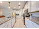 Bright kitchen with white cabinets, granite countertops, tiled floor and stainless steel appliances at 6807 Habitat Dr, St Cloud, FL 34773
