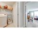 Convenient laundry room setup with washer, dryer, shelving, and easy access to the main bedroom at 6807 Habitat Dr, St Cloud, FL 34773