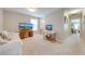 Bright living room featuring comfortable seating, neutral paint, and natural light from the window at 6807 Habitat Dr, St Cloud, FL 34773