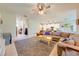 Open-concept living room with a sectional sofa, leading to kitchen and dining areas at 6807 Habitat Dr, St Cloud, FL 34773