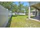Spacious backyard with a privacy fence, lawn, and mature trees at 7167 Winding Lake Cir, Oviedo, FL 32765