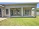 View of the home's covered patio, sliders, and backyard at 7167 Winding Lake Cir, Oviedo, FL 32765