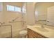 Bathroom with shower-tub combo and vanity with ample lighting at 7167 Winding Lake Cir, Oviedo, FL 32765
