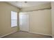 Carpeted bedroom with a double door closet and a large bright window at 7167 Winding Lake Cir, Oviedo, FL 32765