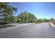 Community entrance with a landscaped median and gate at 7167 Winding Lake Cir, Oviedo, FL 32765