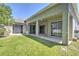 Exterior view of the home's patio with a grassy lawn area at 7167 Winding Lake Cir, Oviedo, FL 32765