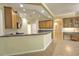 Open kitchen offers seating at the breakfast bar and views to the adjacent rooms at 7167 Winding Lake Cir, Oviedo, FL 32765