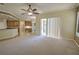 Living room with view of breakfast nook and kitchen, featuring neutral carpeting and plenty of light at 7167 Winding Lake Cir, Oviedo, FL 32765