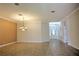 Spacious living room with neutral paint colors and decorative lighting fixture at 7167 Winding Lake Cir, Oviedo, FL 32765