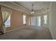 Large main bedroom featuring plush carpeting, tray ceilings, and sliding door access to the lanai at 7167 Winding Lake Cir, Oviedo, FL 32765