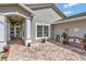 Welcoming front entry with arched porch, brick pavers, and a charming seating area at 725 High Vista Dr, Davenport, FL 33837