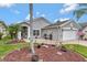 Lovely home featuring a paver driveway, tropical landscaping, and an attached two-car garage at 725 High Vista Dr, Davenport, FL 33837