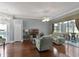 Spacious living room with hardwood floors, stylish furniture, and sliding glass doors to the lanai at 725 High Vista Dr, Davenport, FL 33837