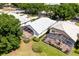 Aerial view showing a screened lanai, beige stucco exterior, and tile roof at 7264 Hawksnest Blvd, Orlando, FL 32835