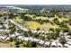 Community aerial view showcasing location on the golf course with lake in background at 7264 Hawksnest Blvd, Orlando, FL 32835