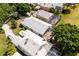Aerial view showing the neighborhood, tile roof, screened lanai, and mature trees at 7264 Hawksnest Blvd, Orlando, FL 32835