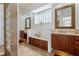 Bright, stylish bathroom features dual vanities, ample cabinet space, and glass block accents at 7264 Hawksnest Blvd, Orlando, FL 32835