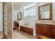 Bright bathroom features a double vanity, glass block window, and tile flooring at 7264 Hawksnest Blvd, Orlando, FL 32835