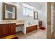 Bright bathroom features a double vanity, glass block window, and tile flooring at 7264 Hawksnest Blvd, Orlando, FL 32835