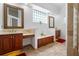 Spa-like bathroom features dual vanities, modern fixtures, and stylish glass block windows at 7264 Hawksnest Blvd, Orlando, FL 32835