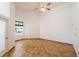 Spacious bedroom boasts a vaulted ceiling, tile flooring, and a bright window at 7264 Hawksnest Blvd, Orlando, FL 32835