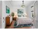 Comfortable bedroom features a queen size bed, natural light, and modern décor at 7264 Hawksnest Blvd, Orlando, FL 32835