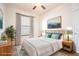 Cozy bedroom with a soft color palette, plush bedding, and natural light from the large window at 7264 Hawksnest Blvd, Orlando, FL 32835