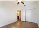 Bedroom with wood floors, ceiling fan, walk-in closet, and ensuite bathroom at 7264 Hawksnest Blvd, Orlando, FL 32835
