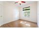 Bright bedroom with wood floor, ceiling fan, and window with view at 7264 Hawksnest Blvd, Orlando, FL 32835