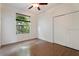 Bedroom with wood floors, ceiling fan, window with blinds, and closet at 7264 Hawksnest Blvd, Orlando, FL 32835