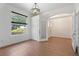 Inviting entryway with arched doorway, hardwood floors, and decorative transom window at 7264 Hawksnest Blvd, Orlando, FL 32835
