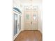 Bright entryway featuring double doors, side lights, and wood floors at 7264 Hawksnest Blvd, Orlando, FL 32835