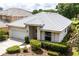 Exterior view of home with a garage, manicured bushes, and a neutral paint color at 7264 Hawksnest Blvd, Orlando, FL 32835